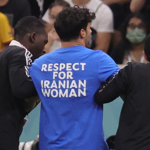 epa10335243 Stewards remove a pitch invader during the FIFA World Cup 2022 group H soccer match between Portugal and Uruguay at Lusail Stadium in Lusail, Qatar, 28 November 2022. EPA/Abir Sultan