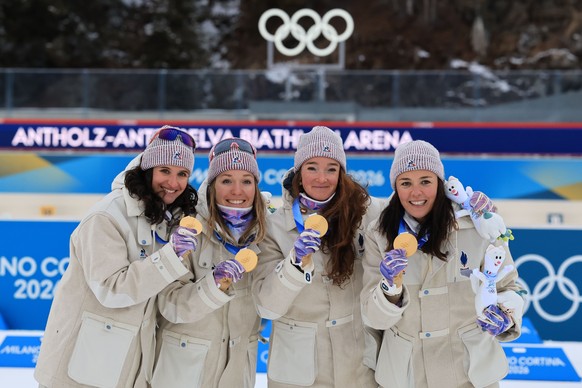 epa12754592 (L-R) Gold medalists Julia Simon of France, Oceane Michelon of France, Lou Jeanmonnot of France and Camille Bened of France celebrate during the victory ceremony for the Women's 4x6km ...
