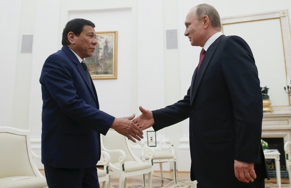 Russian President Vladimir Putin, right, shakes hands with Philippine President Rodrigo Duterte during their meeting in the Kremlin in Moscow, Russia, Tuesday, May 23, 2017. (Maxim Shemetov/Pool Photo ...