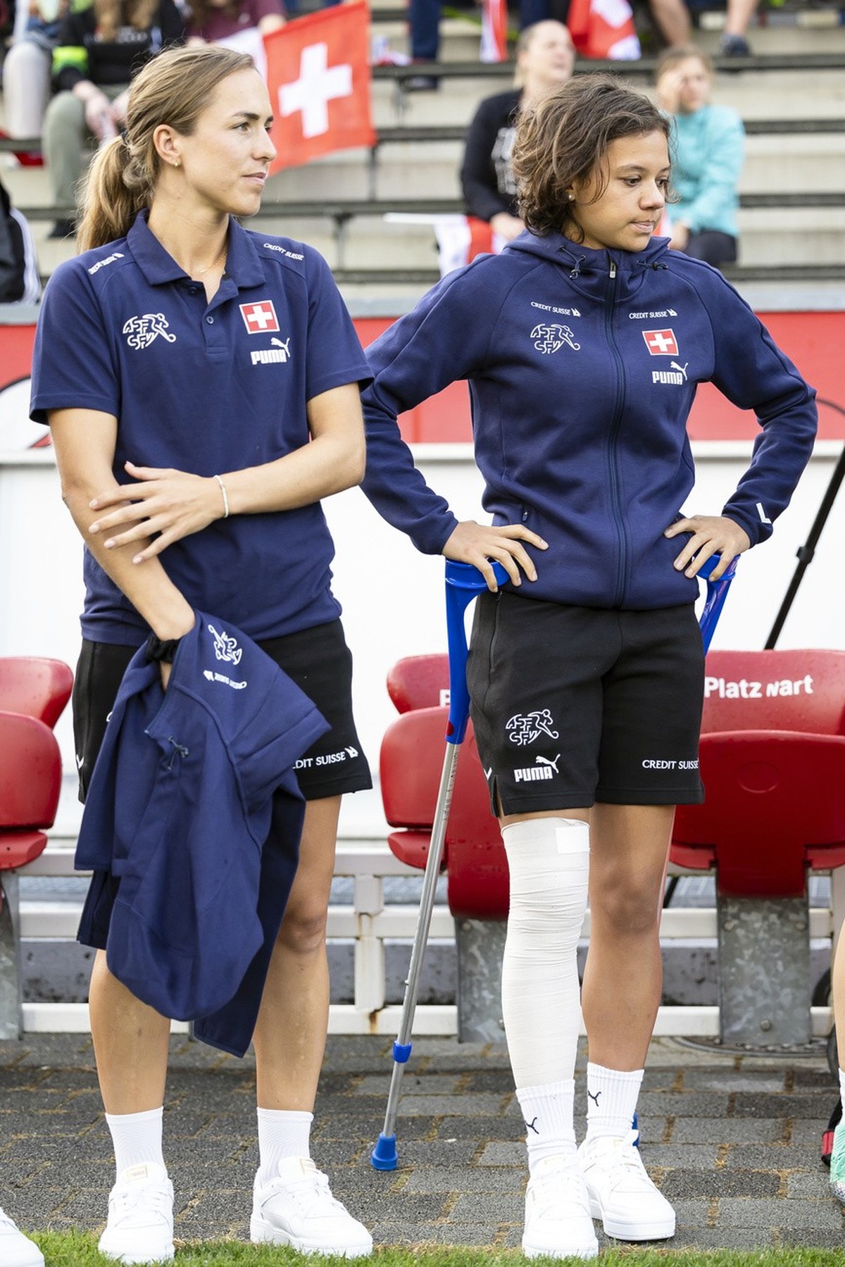 Switzerland's injured Iman Beney, right, looks on next to Lia Waelti, left, before a women's international friendly soccer match between Switzerland and Morocco at the Schuetzenwiese stadium ...