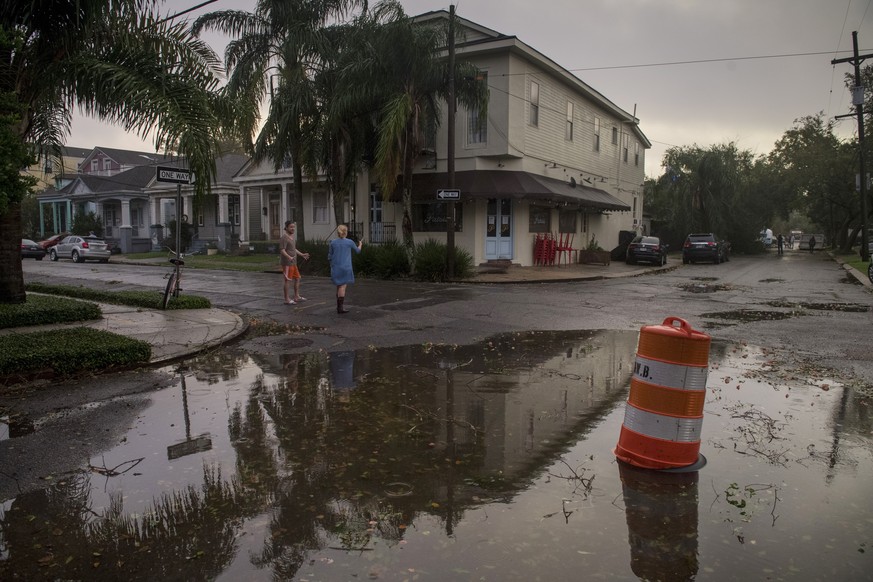 Residents come out to assess the damage from Hurricane Zeta on Wednesday, Oct. 28, 2020, near the restaurant Patois in New Orleans. (Chris Granger/The Times-Picayune/The New Orleans Advocate via AP)