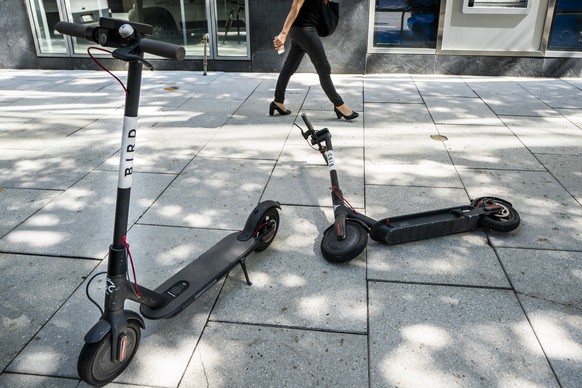 epa06886481 Bird electric scooters await customers in downtown Washington, DC, USA, 13 July 2018. The 2 billion US dollar startup, whose electric scooters are largely manufactured in China, could beco ...