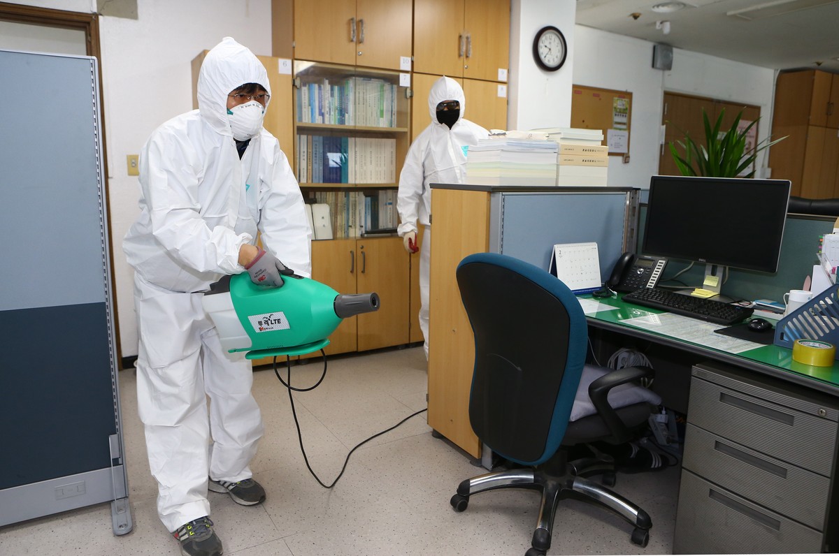 epa08236370 A health worker disinfects an office in Daegu, South Korea, 22 February 2020. South Korea's prime minister declared the southeastern cities of Daegu and Cheongdo as 'special care ...
