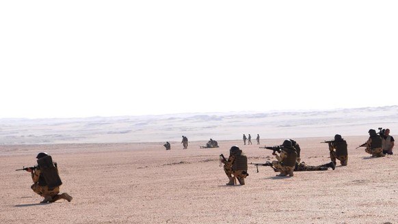 In this image released in Tuesday, Sept. 22, 2015 on the official Facebook account of the Egyptian military spokesman, soldiers take up combat positions during an operation near the Bahriyah Oasis in ...