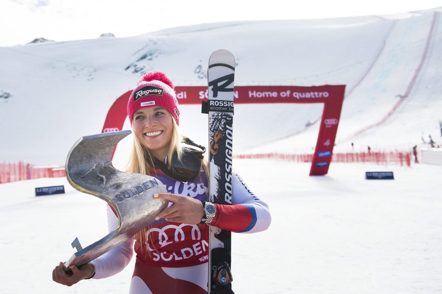 Lara Gut of Switzerland celebrates with the trophy after winning the women's Giant Slalom race of the FIS Alpine Ski World Cup season on the Rettenbach glacier, in Soelden, Austria, Saturday, Oct ...