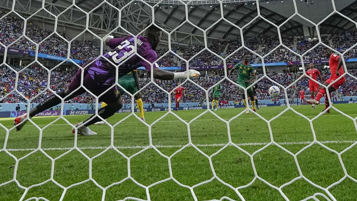 Switzerland's Breel Embolo, right, scores his side's opening goal during the World Cup group G soccer match between Switzerland and Cameroon, at the Al Janoub Stadium in Al Wakrah, Qatar, Th ...