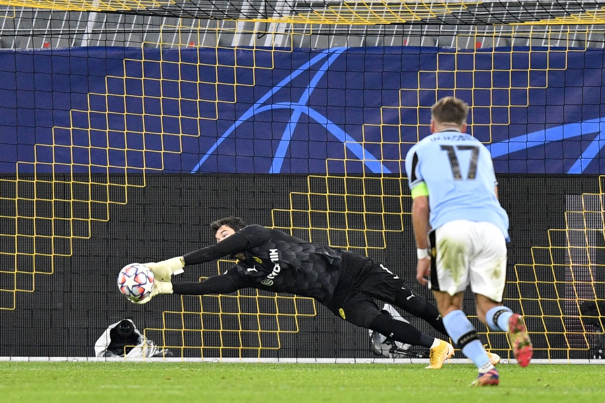 Dortmund's goalkeeper Roman Buerki makes a save in front Lazio's Ciro Immobile during the Champions League, Group F, soccer match between Borussia Dortmund and Lazio at the Signal Iduna Park ...
