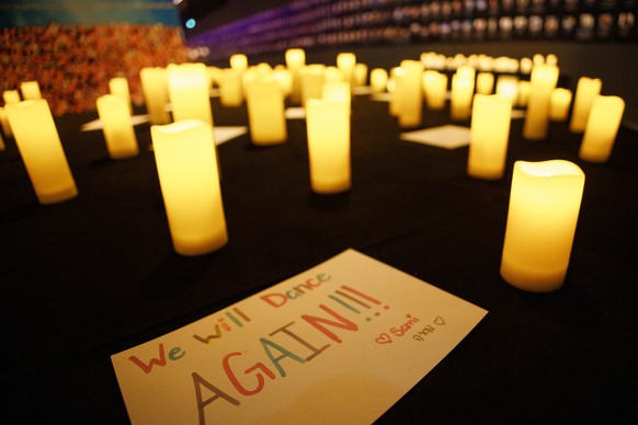 epa12434953 A message that reads 'We will dance again!' lies between artificial candles during a press day prior to the opening of the Nova Music Festival exhibition at former Tempelhof Airp ...