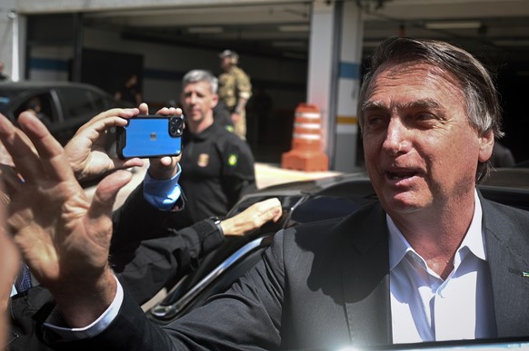 epa10592678 Former president of Brazil Jair Bolsonaro leaves the headquarters of the Federal Police after giving testimony, for the anti-democratic attacks that took place in January, in Brasilia, Bra ...