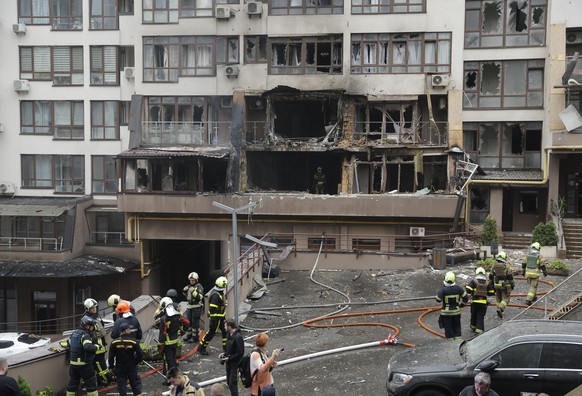 epa12250609 Ukrainian rescuers work at the site of a drone strike on a residential building in Kyiv, Ukraine, 21 July 2025, amid the Russian invasion. At least two people died and 15 people were injur ...