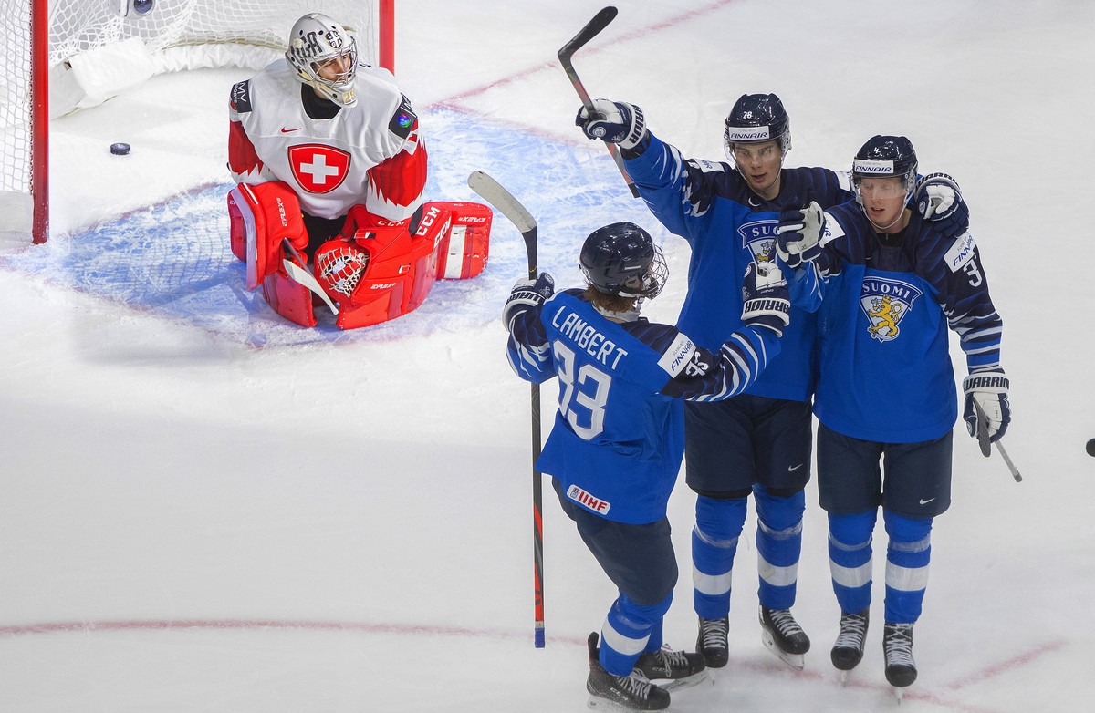 Finland's Brad Lambert (33), Henri Nikkanen (28) and Aku Raty (34) celebrate a goal as Switzerland goalie Thibault Fatton (29) looks on during third-period IIHF World Junior Hockey Championship a ...