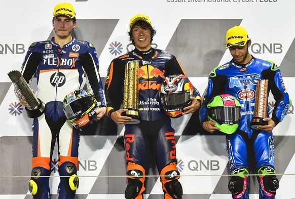 epa08278857 Japanese Moto2 rider Tetsuta Nagashima (C) of the Red Bull KTM Ajo team smiles on the podium after winning the Moto2 race at the Motorcycling Grand Prix of Qatar at Losail International Ci ...