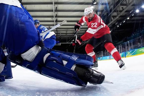 Switzerland's Nino Niederreiter (22) challenges with Italy's Damian Clara (20) during a men's ice hockey qualification playoff game between Switzerland and Italy at the 2026 Winter Olym ...