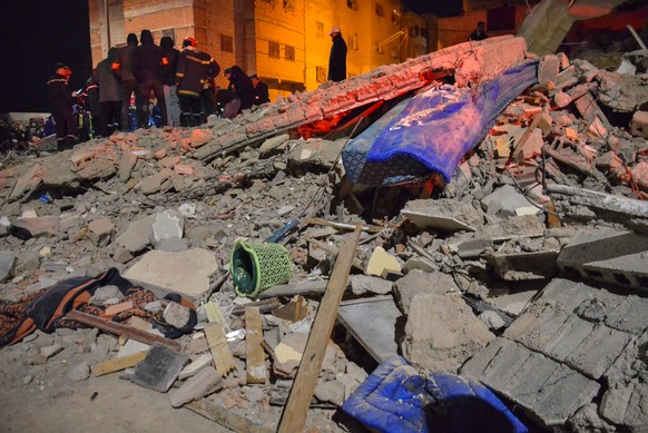 Rescue workers and residents search for survivors amid the wreckage of two collapsed buildings in Fez, Morocco, Tuesday, Dec. 9, 2025. (AP Photo/Ahmed Alaoui Mrani)
Morocco Fez Building Collapse