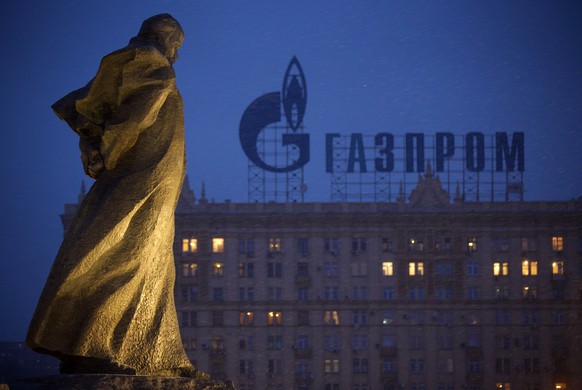 FILE - In this March 4, 2014 file photo, a monument to Ukrainian poet and writer Taras Shevchenko is silhouetted against an apartment building with a sign advertising Russia&#039;s natural gas giant G ...
