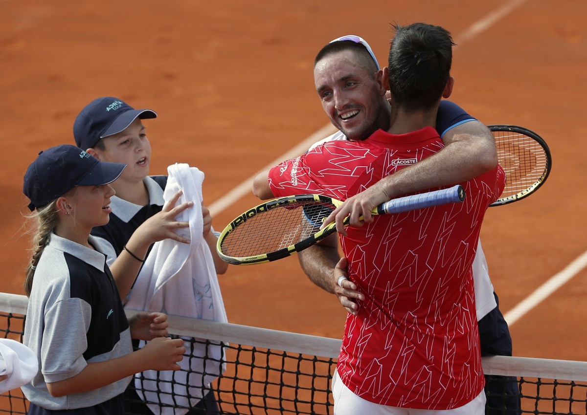 In this Saturday, June 13, 2020 photo, Serbia's Novak Djokovic, front right, hugs with Serbia's Viktor Troicki after their match of the Adria Tour charity tournament in Belgrade, Serbia. Nov ...