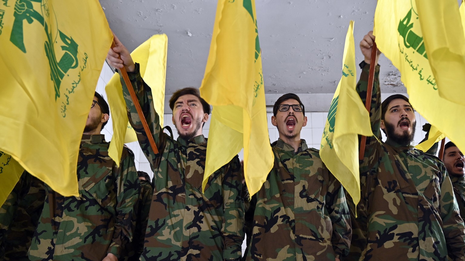 epa10960381 Hezbollah militants shout slogans during the funeral of Hezbollah fighter Qasim Ibrahim Abu Taam, who was killed a previous day in southern Lebanon, in the southern suburb of Beirut, Leban ...