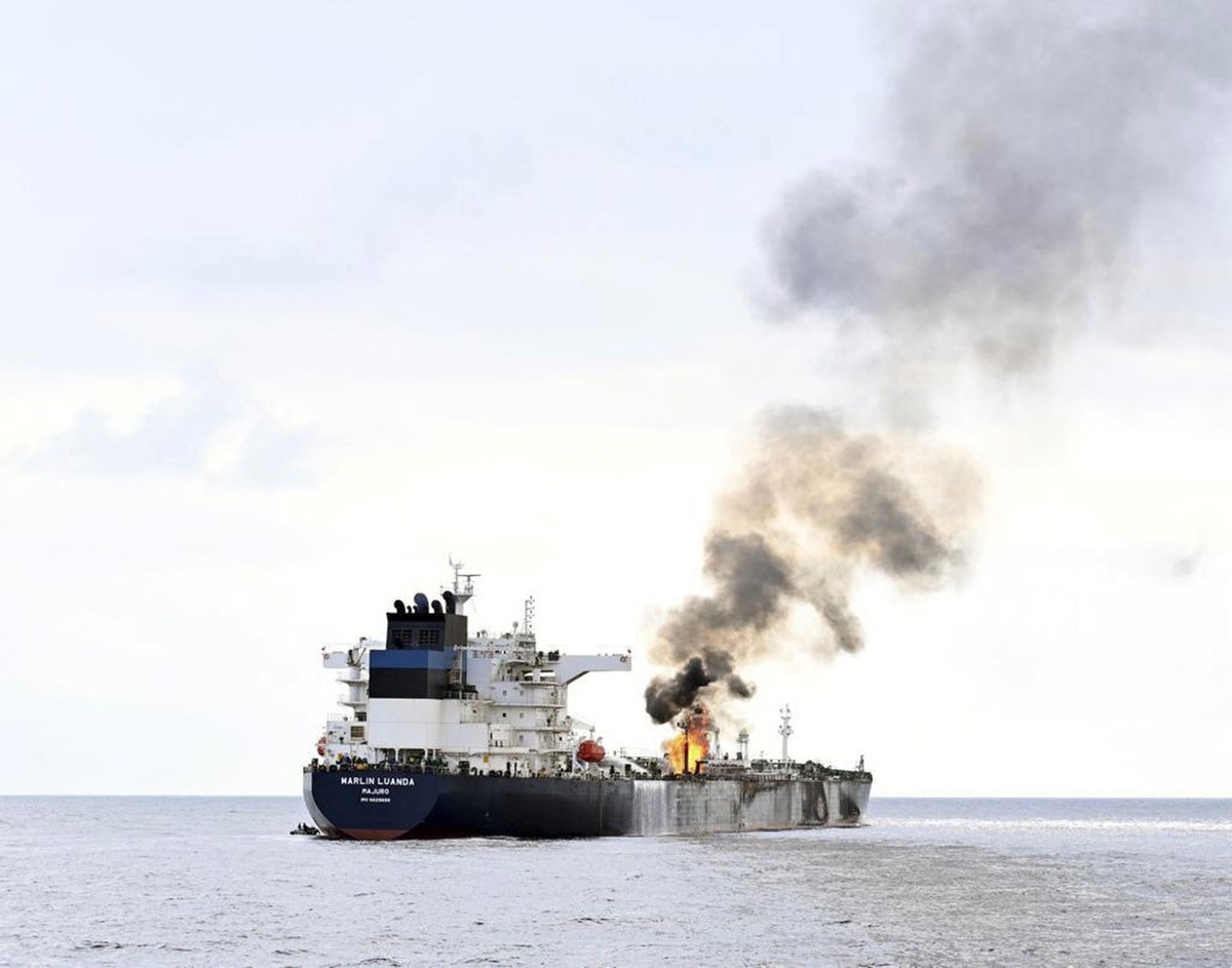 In this photo provided by the Indian Navy on Saturday, Jan. 27, 2024, a view of the oil tanker Marlin Luanda in the background, on fire after an attack, in the Gulf of Aden, taken from the Indian navy ...