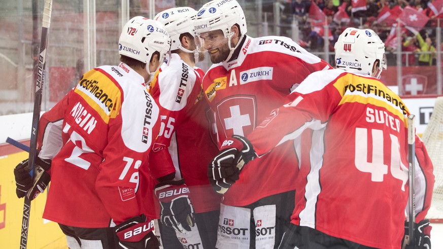 SwitzerlandÕs Denis Malgin, SwitzerlandÕs Romain Loeffel, SwitzerlandÕs Philippe Furrer and SwitzerlandÕs Pius Suter, from left, react after the first goal (1-0) during a friendly ice hockey game betw ...