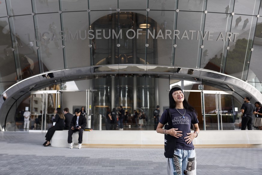epa13256593 Janet Jacobs waits outside the lobby during the opening day of the Lucas Museum of Narrative Art in Los Angeles, California, USA, 22 September 2026. The museum, founded by US filmmaker Geo ...