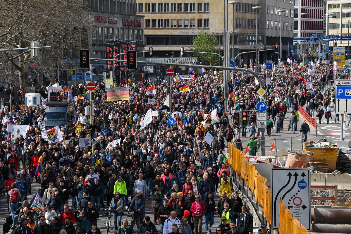 epa09113035 Protesters during a demonstration held by the ?Querdenker' (lateral thinkers) movement against the German government's coronavirus restrictions in Stuttgart, Germany, 03 April 20 ...