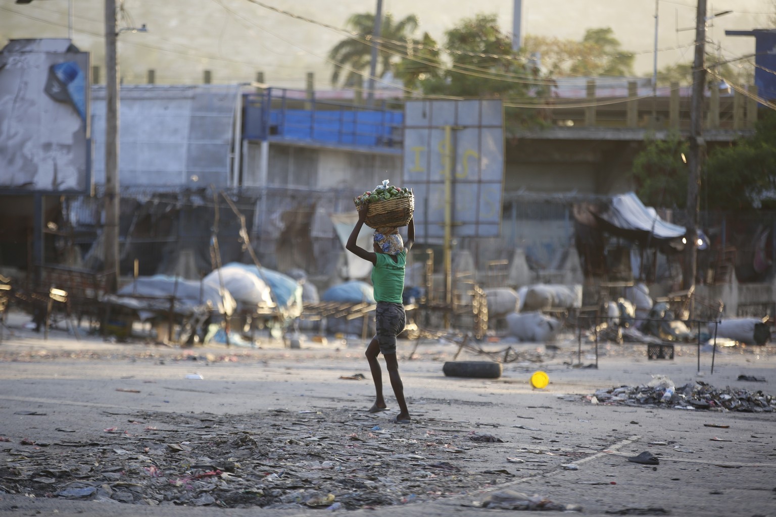 A woman crosses a street after clashes between police and gunmen at the Portail neighborhood of Port-au-Prince, Haiti, Thursday, Feb. 29, 2024. (AP Photo/Odelyn Joseph)