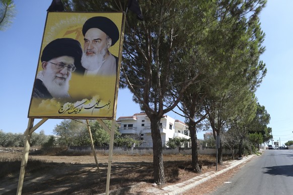 Portraits of the late revolutionary founder Ayatollah Khomeini and the Supreme Leader Ayatollah Ali Khamenei, are displayed at the entrance of the Lebanese-Israeli border village of Yaroun, south Leba ...