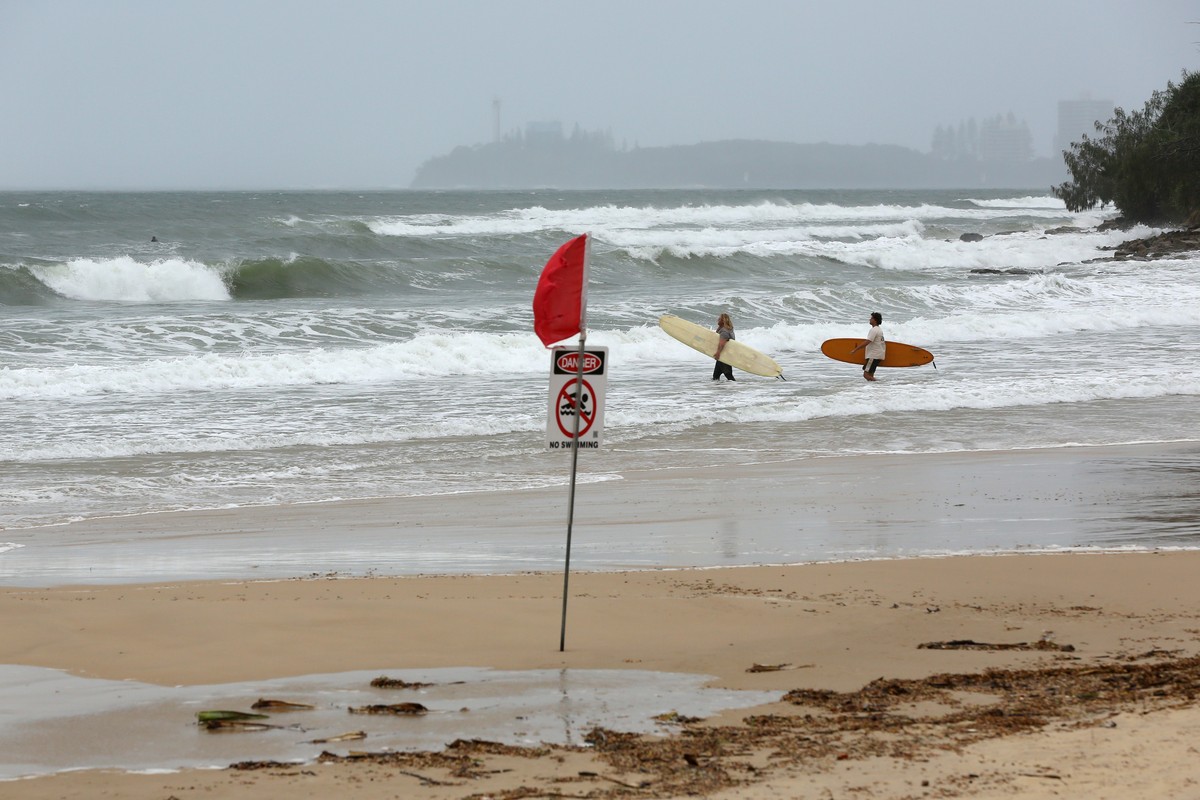 epa12702563 Surfers enter the water at Alexandra Headland Beach as strong winds and increasing swells bear down on the Sunshine Coast, Queensland, Australia, 03 February 2026. EPA/DANNY CASEY AUSTRALI ...