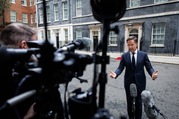 epa11652464 NATO Secretary General Mark Rutte (R) gestures as he speaks to members of the media following a bilateral meeting with the British prime minister at Downing Street, London, Britain, 10 Oct ...