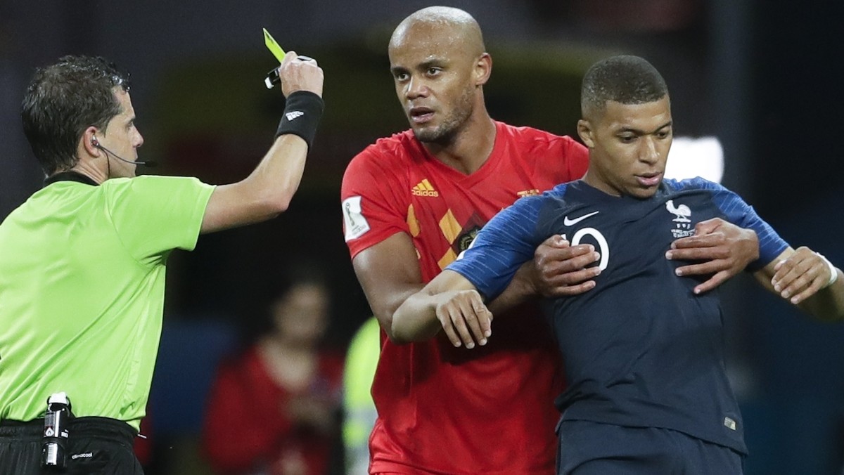 Referee Andres Cunha from Uruguay shows a yellow card to France's Kylian Mbappe during the semifinal match between France and Belgium at the 2018 soccer World Cup in the St. Petersburg Stadium, i ...