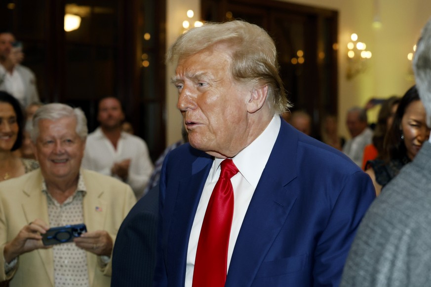 Republican presidential candidate former President Donald Trump walks through the crowd during the Club Golf Awards at Trump International Golf Course in West Palm Beach, Fla., Sunday, March 24, 2024. ...