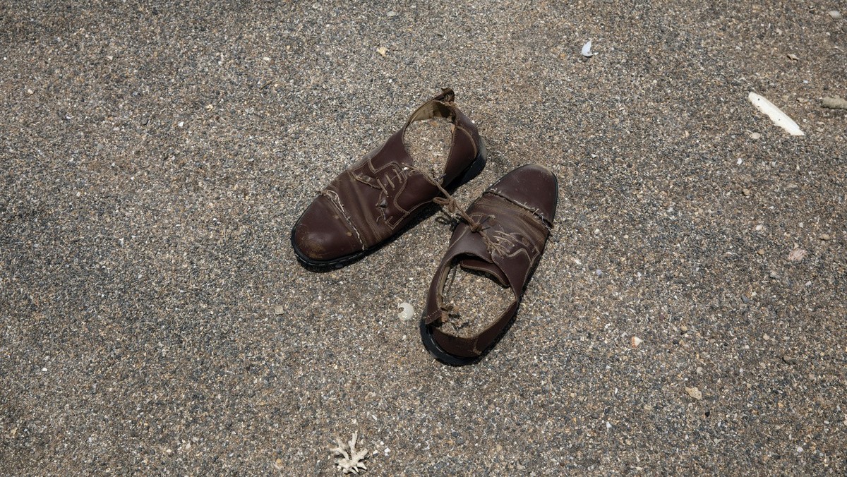 This July 15, 2019 photo, shows a pair of shoes belonging to a migrant left on the sand where African migrants gather at night to embark a boat in the uninhabited coast outside the town of Obock, the  ...