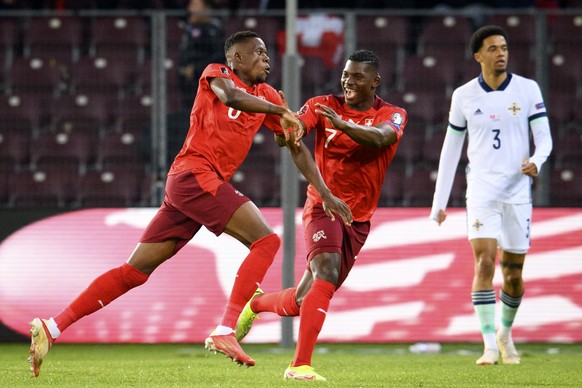 Switzerland&#039;s forward Breel Embolo, center, and Switzerland&#039;s midfielder Denis Zakaria, left, celebrate the first goal cancelled after consultation of the VAR in front of Northern Ireland&#0 ...