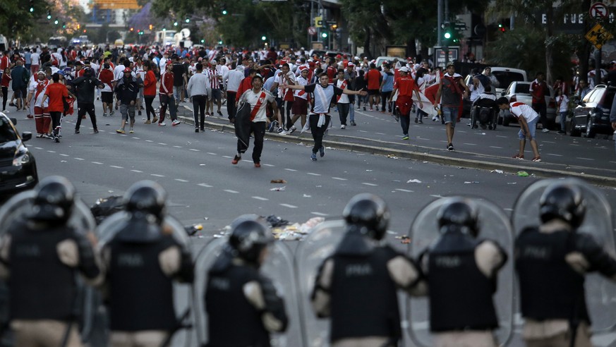 Argentina River Plate fans clash with riot police outside the Antonio Vespucio Liberti stadium prior the final soccer match of the Copa Libertadores between River Plate and Boca Juniors, in Buenos Air ...