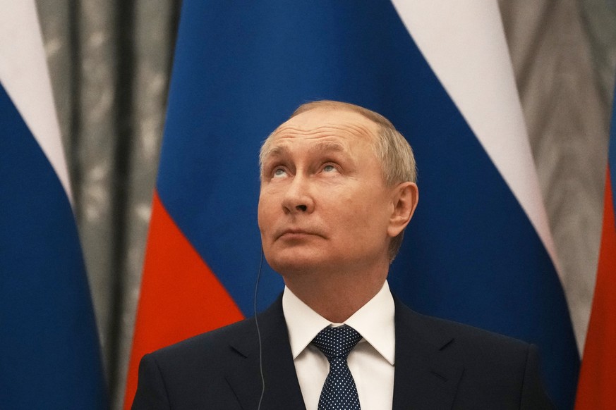 epa09736555 Russian President Vladimir Putin looks up during a press conference with French President Emmanuel Macron after their talks in the Kremlin in Moscow, Russia, 07 February2022. International ...