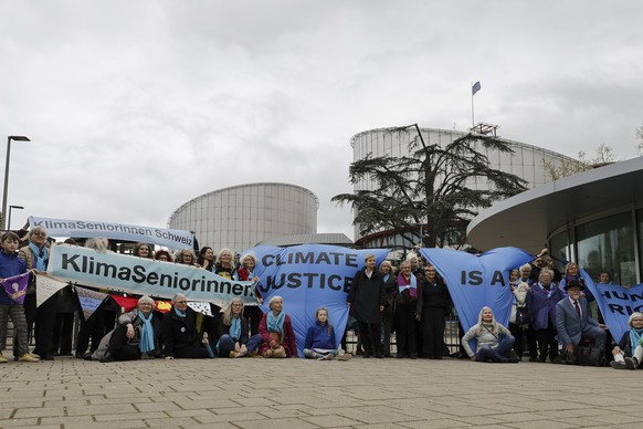 epa11266969 Activists of Climate Seniors from Switzerland pose with protest banners in front of the European Court of Human Rights (ECHR), before the judgement in a case against different European cou ...