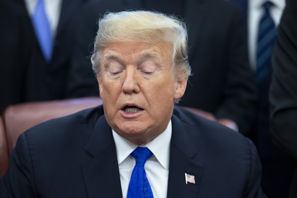 epa07224683 US President Donald J. Trump delivers remarks to members of the news media beside lawmakers and religious leaders during a signing ceremony for H.R. 390, the &#039;Iraq and Syria Genocide  ...