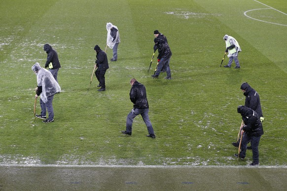 Stadium staff members work on the pitch prior to the 2018 FIFA World Cup play-off second leg soccer match between Switzerland and Northern Ireland in the St. Jakob-Park stadium in Basel, Switzerland,  ...