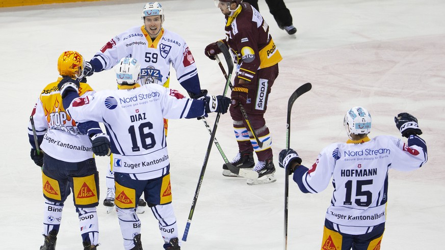 Zug&#039;s forward Dario Simion #59 celebrates his goal with teammates Zug&#039;s center Jan Kovar, of Czech Republic, left, Zug&#039;s defender Raphael Diaz #16, and Zug&#039;s forward Gregory Hofman ...