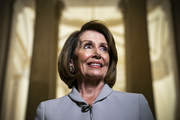 epa07258762 Democratic House Minority Leader and likely next Speaker of the House from California Nancy Pelosi speaks with the media while walking through the US Capitol prior to meeting with US Presi ...