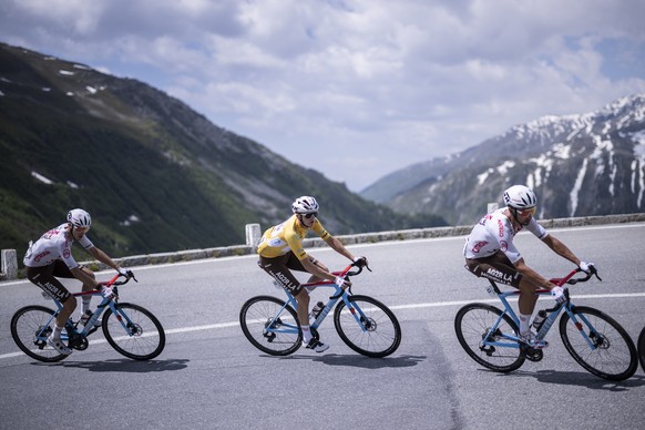 epa10692196 (from R) AG2R Citroen Team riders Mikael Cherel of France, overall leader Felix Gall of Austria and Clement Berthet of France climb the Furka pass during the fifth stage, a 211 km race fro ...