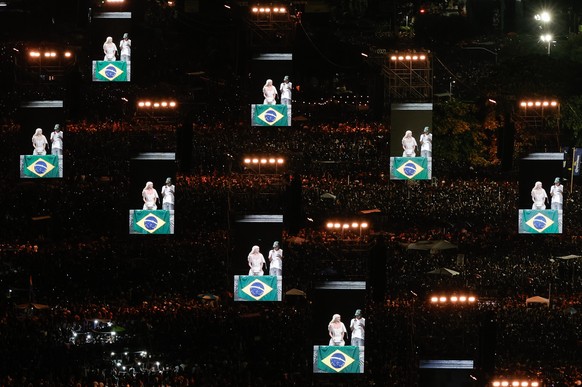 epa12072306 Displays show American singer and songwriter Lady Gaga performing during a free mega concert at Copacabana beach in Rio de Janeiro, Brazil, 03 May 2025. EPA/ANDRE COELHO