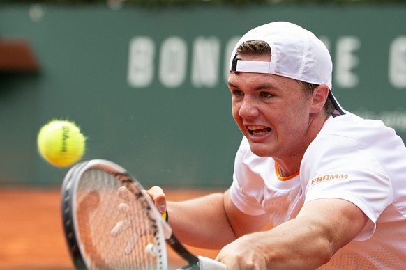 Dominic Stephan Stricker, of Switzerland, returns a ball to Marin Cilic, of Croatia, during their first round match, during their first round match, at the ATP 250 Geneva Open tournament in Geneva, Sw ...