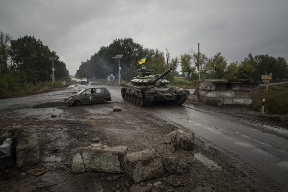 FILE - A Ukrainian tank drives past a former Russian checkpoint in the recently retaken area of Izium, Ukraine, Sept. 16, 2022. A swift Ukrainian counteroffensive earlier this month that forced Russia ...
