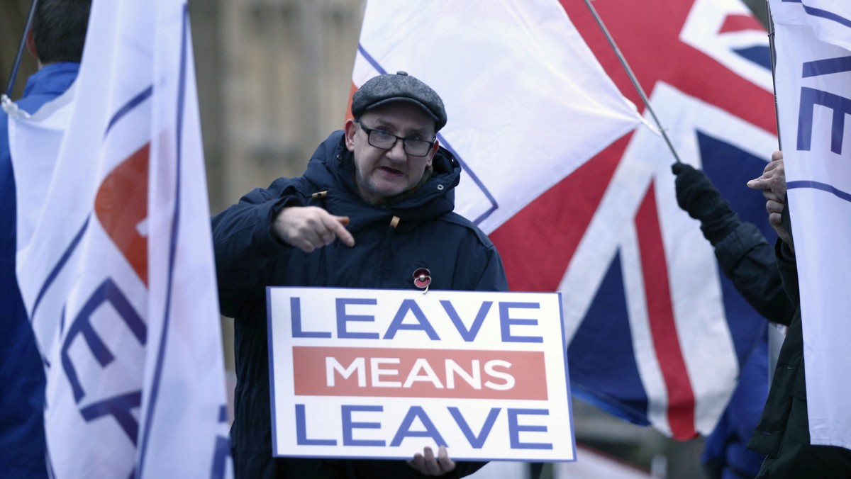 Pro-Brexit demonstrators wave flags and signs alongside anti-Brexit demonstrators, outside Parliament in London Monday Jan. 7, 2019. Parliament is expected to vote on Prime Minister Theresa May's ...