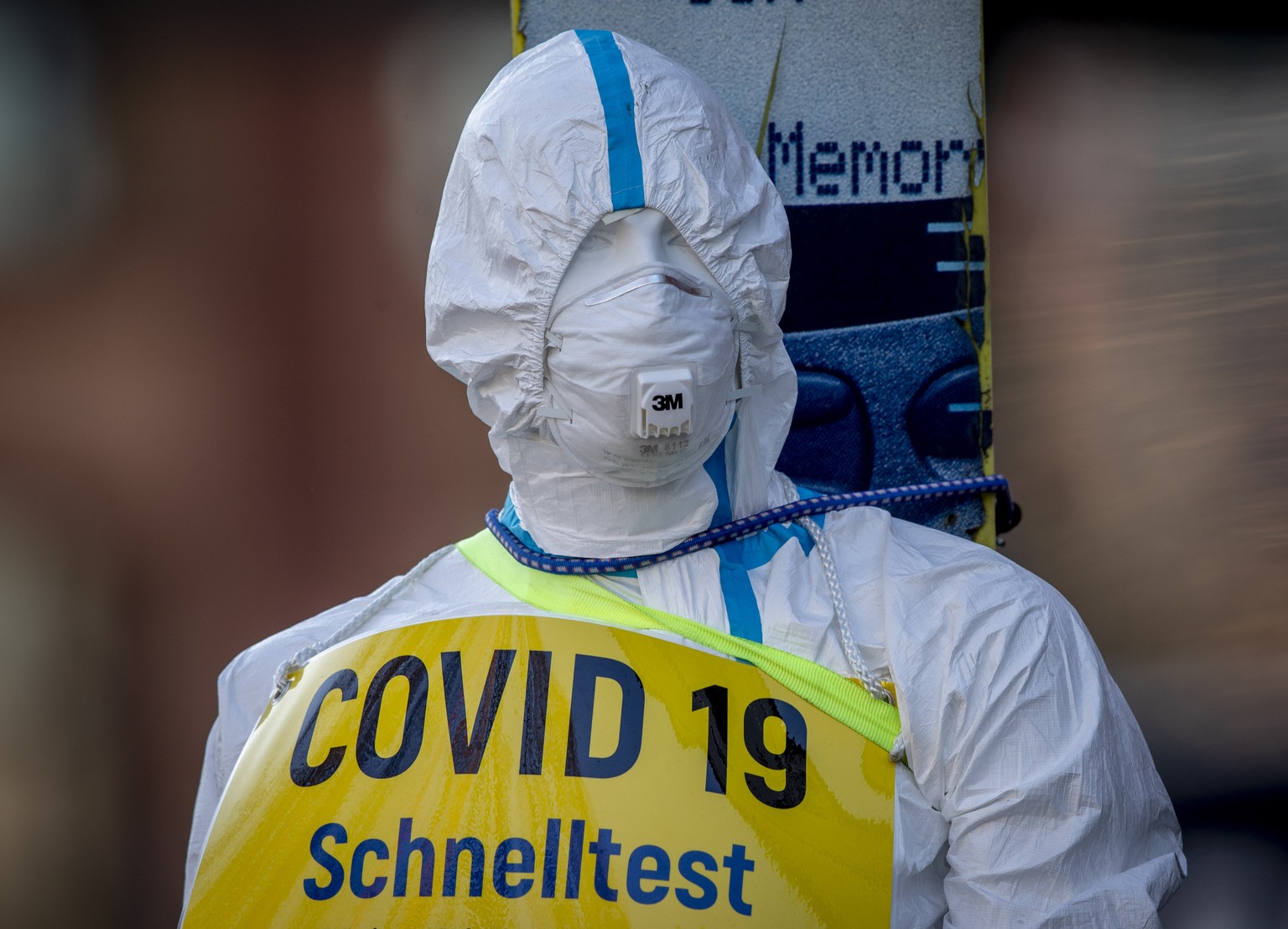 An advertising figure for Covid-19 rapid test stands in front of a small test center in Frankfurt, Germany, Sunday, March 7, 2021. From Monday on free corona tests are offered in Germany. Word reads & ...