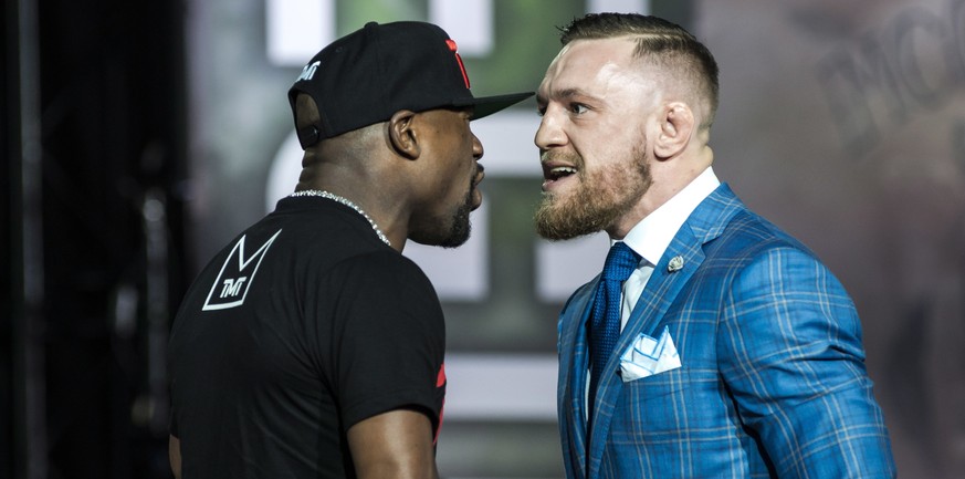 Floyd Mayweather, left, and Conor McGregor exchange harsh words during a promotional stop in Toronto on Wednesday, July 12, 2017, for their upcoming boxing match in Las Vegas. (Christopher Katsarov/Th ...