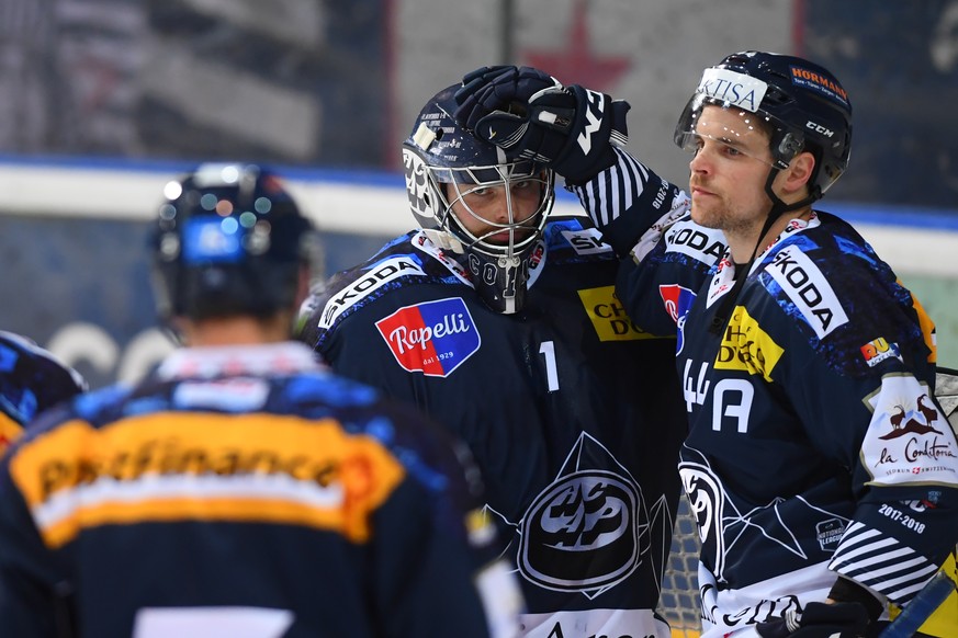 Ambri&#039;s player Nick Plastino, right, celebrates the victory with Ambri&#039;s goalkeeper Benjamin Conz, after the fifth placement round game of National League Swiss Championship 2017/18 between  ...