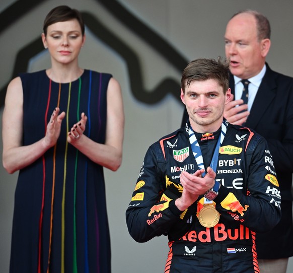 epa10660365 The winner Dutch Formula One driver Max Verstappen of Red Bull Racing (C) reacts on the podium with his medal, as Princess Charlene of Monaco (L) and Prince Albert II of Monaco (C-R) appla ...