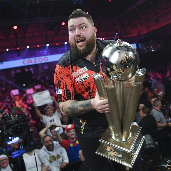 epa10387909 Michael Smith of England poses with the Sid Waddell trophy after winning the PDC World Darts Championship final against Michael van Gerwen of the Netherlands at Alexandra Palace in London, ...